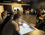 Estudantes em aula com mesa interativa na sala Betha da Unoeste Guarujá. 