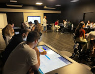 Aula dinâmica na Sala Betha com estudantes de Biomedicina da Unoeste Guarujá explorando recursos digitais. 