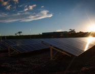 Painéis solares da Faculdade de Energias Renováveis ao pôr do sol, simbolizando a geração de energia limpa e sustentabilidade.